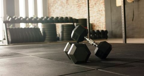 Hex Dumbbells on Gym Floor Highlight Fitness Strength Theme