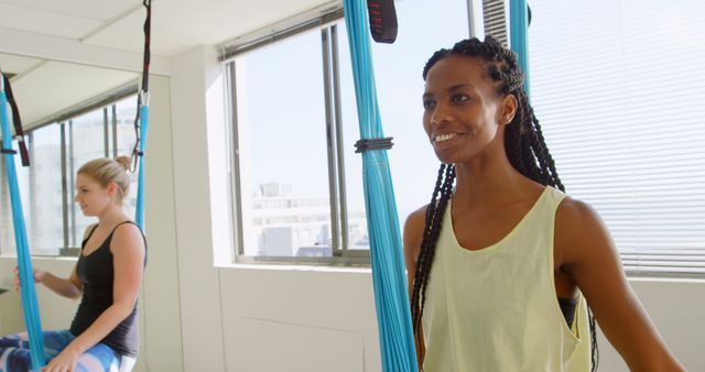 Women Enjoying Aerial Yoga Session with Bright Natural Lighting - Download Free Stock Images Pikwizard.com