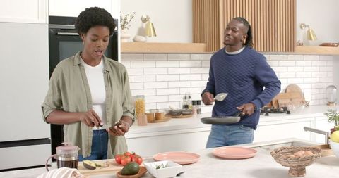 Couple Cooking Together in Modern Kitchen Preparing Food