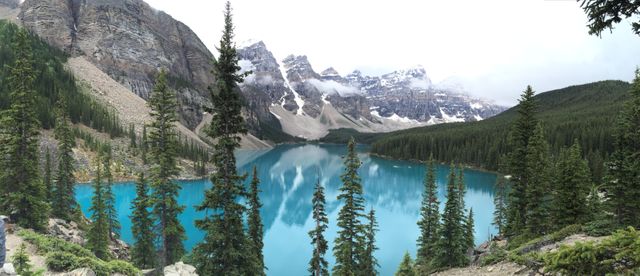 Turquoise Mountain Lake Surrounded by Pine Forest and Snow-Capped Peaks - Download Free Stock Photos Pikwizard.com