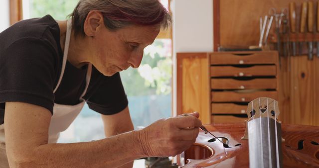 Senior Female Violin Maker Repairing Musical Instrument in Workshop - Download Free Stock Images Pikwizard.com