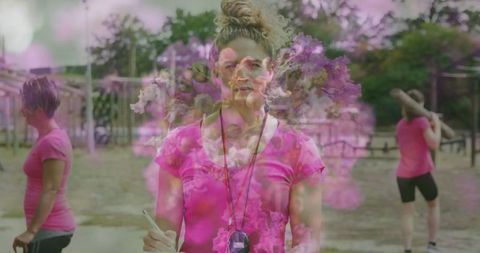 Fitness instructor leading outdoor training wearing pink