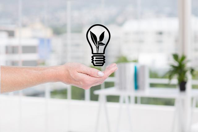Digital composite of hand holding a lightbulb