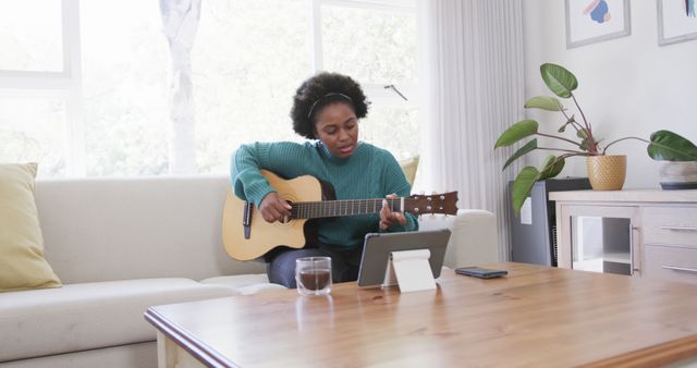 African American Woman Learning Guitar at Home Using Online Tutorial - Download Free Stock Images Pikwizard.com