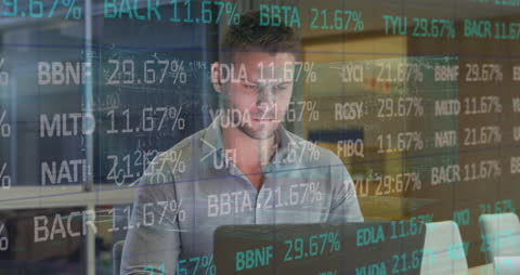 Businessman Analyzing Data on Laptop in Office Environment