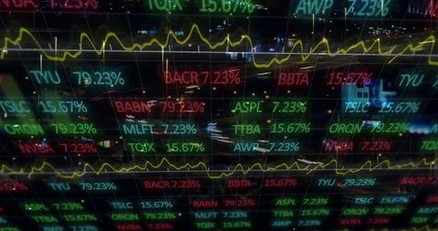 Dynamic financial data displayed over city traffic at night