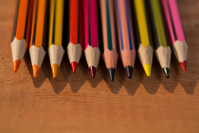 Colorful Pencils Arranged on Wooden Table - Download Free Stock Photos Pikwizard.com