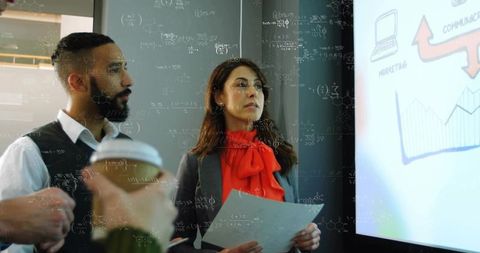 Business professionals analyzing presentation data in modern office