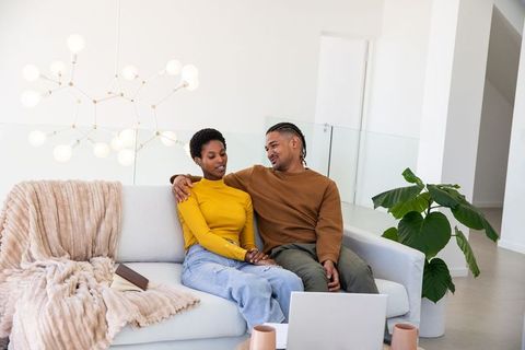 Affectionate couple relaxing in modern minimalist living room