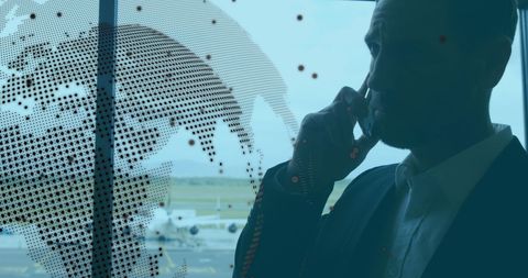 Businessman in Airport Using Smartphone with Digital World Map Overlay