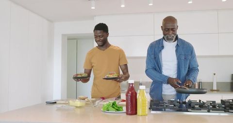 Father and Son Enjoying Bonding Time While Cooking in Kitchen