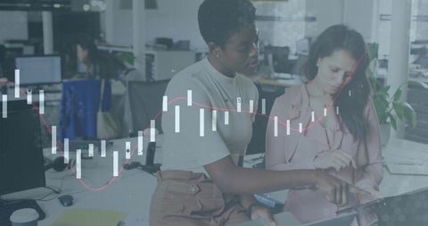 Colleagues Exploring Financial Data in Modern Office