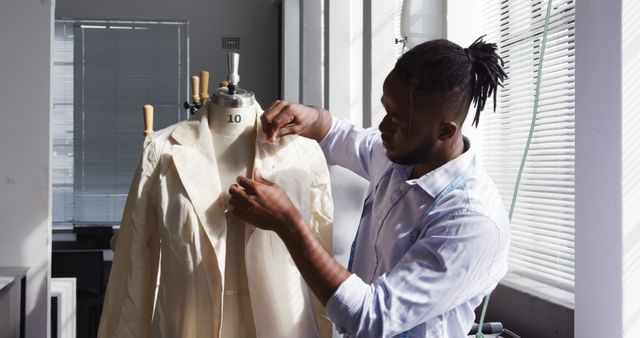 African american male fashion designer sewing clothes in office. Fashion, design, business and work, unaltered.
