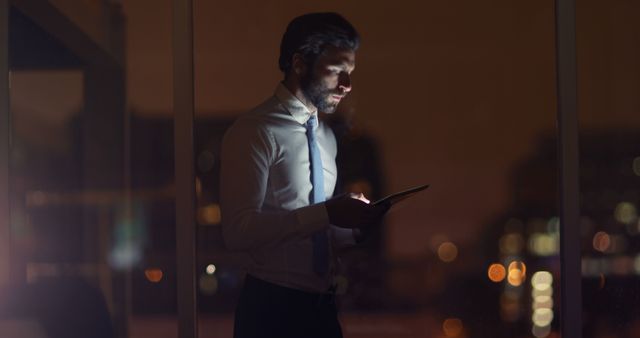 Businessman Working Late at Night with Tablet in Office - Download Free Stock Images Pikwizard.com