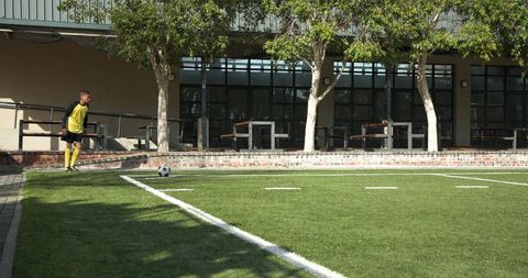 Youth Soccer Practice on School Field with Clear Blue Sky