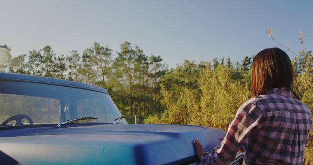 Woman Outdoors in Flannel Shirt Resting Hand on Vintage Truck - Download Free Stock Images Pikwizard.com