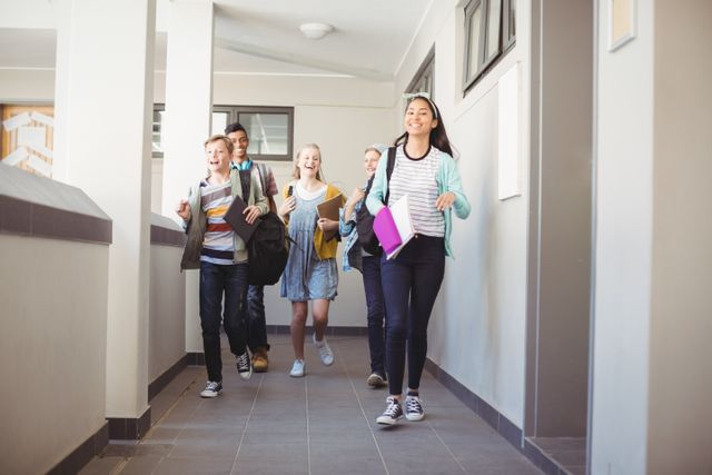 Group of cheerful students running in a school corridor, holding books and backpacks. Ideal for educational content, back-to-school promotions, and youth-oriented advertisements.