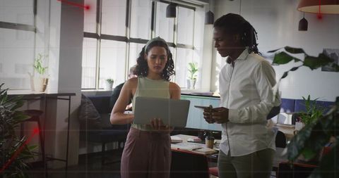 Collaborative Coworkers Engaged in Office Discussion with Laptop