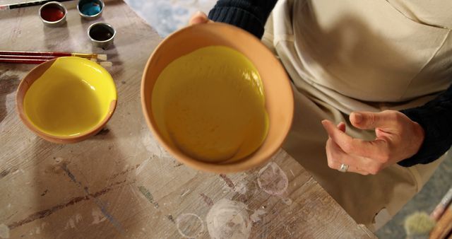 Potter preparing to glaze pottery bowl - Download Free Stock Images Pikwizard.com