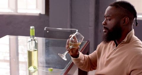Man Enjoys Glass of White Wine at Modern Dining Table - Download Free Stock Images Pikwizard.com