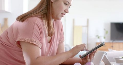 Smiling Biracial Woman Using Tablet in Kitchen Preparing Healthy Meal - Download Free Stock Images Pikwizard.com