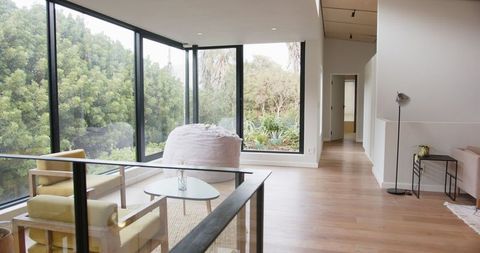 Scandinavian Living Room with Cozy Yellow Chairs and Panoramic View