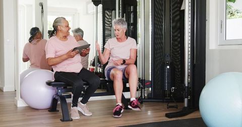 Senior Couples Engaging in Fitness Activity with Tablet