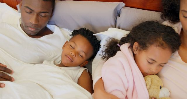 Family Sleeping Together in Bed on a Cozy Morning - Download Free Stock Images Pikwizard.com