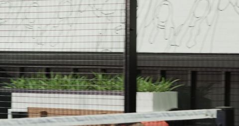 Enthusiastic man playing padel tennis indoors