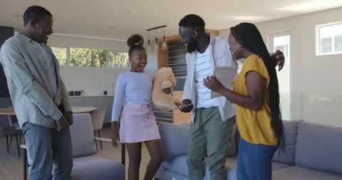 Joyful family meeting with real estate agent in modern home