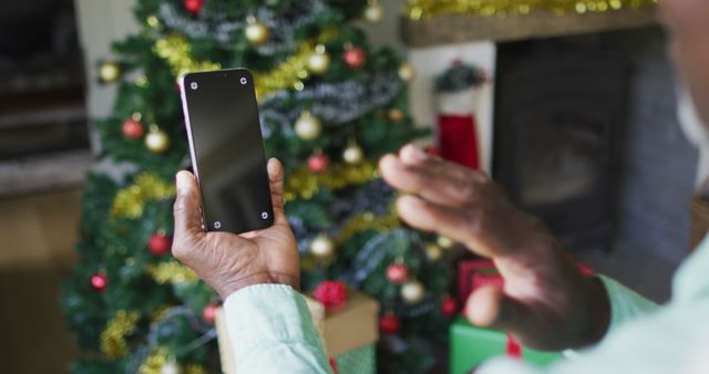 Person Video Chatting on Smartphone During Christmas Celebration at Home - Download Free Stock Images Pikwizard.com