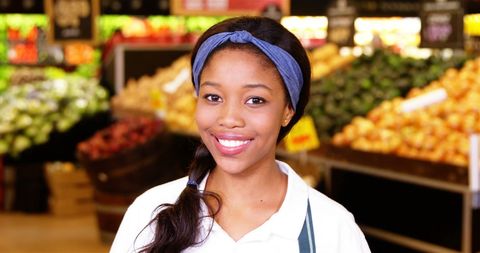 Cheerful Woman Shopping in Fresh Produce Section of Grocery Store