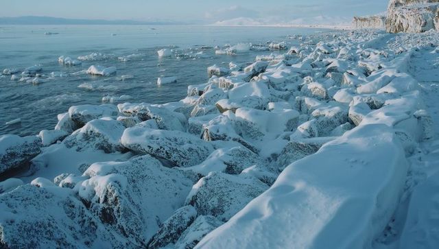 Snow-covered arctic shoreline with icy waters