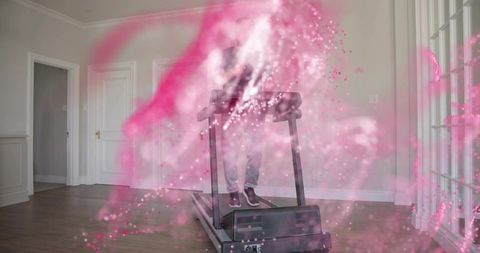 Mature man running on treadmill with pink smoke overlay in spacious minimalist home gym