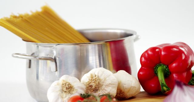 Ingrediants for pasta dish with garlic, red pepper, spaghetti in pot - Download Free Stock Images Pikwizard.com