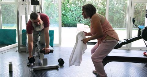 Senior Couple Exercising Together in Home Gym for Wellness and Fitness