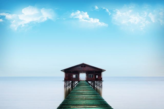 Serene Wooden Cabin on Stilts by Pier - Download Free Stock Photos Pikwizard.com