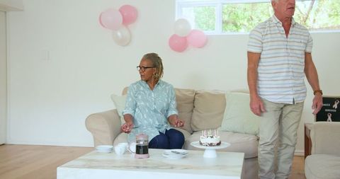Senior Friends Preparing Coffee and Cake in Cozy Living Room