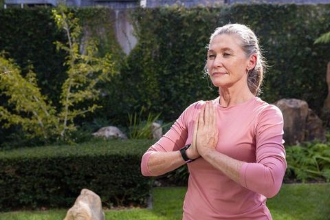 Senior Woman Practicing Yoga in Serene Backyard