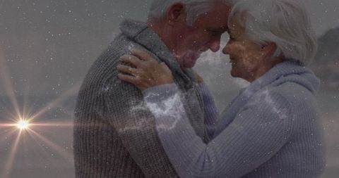 Elderly couple embracing on misty lakeshore with ethereal starfield overlay and lens flare