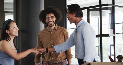 Diverse Colleagues Greeting in Modern Office Setting
