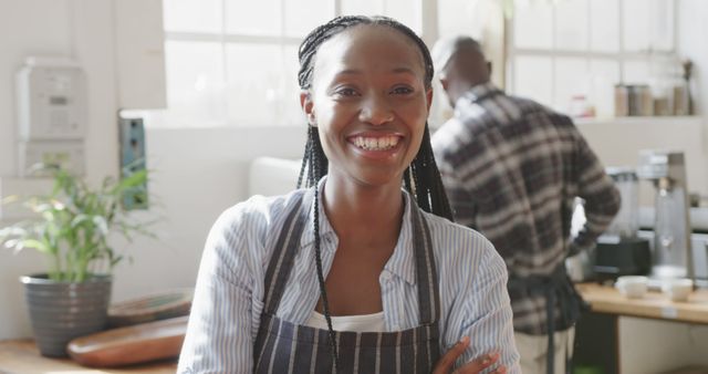 Smiling Woman in Apron, Working in Modern Kitchen - Download Free Stock Images Pikwizard.com