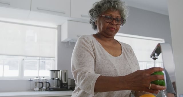 Senior Woman Preparing Fresh Vegetables in Modern Kitchen - Download Free Stock Images Pikwizard.com