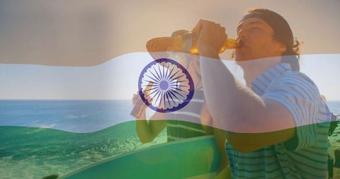 Friends Enjoying Refreshments on Beach During Sunset