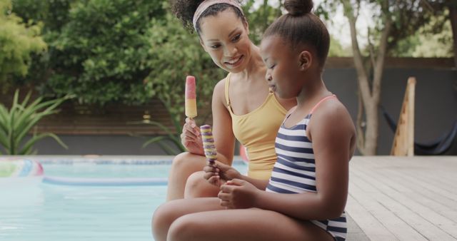 Mother and Daughter Eating Popsicles by Pool - Download Free Stock Images Pikwizard.com