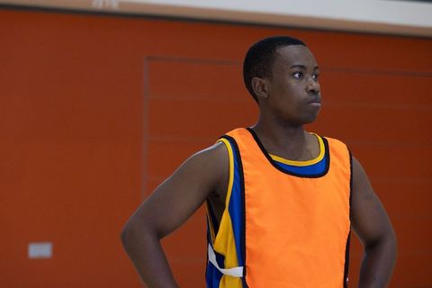 Focused Basketball Player in Gym Wearing Training Bib