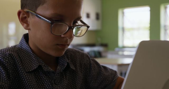 Focused Young Boy Wearing Glasses Using Laptop in Classroom - Download Free Stock Images Pikwizard.com