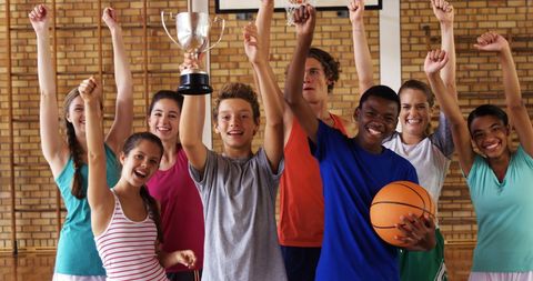Joyful Teens Celebrating Victory with Trophy in Basketball Court - Download Free Stock Images Pikwizard.com
