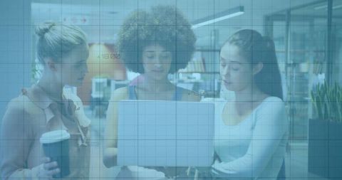 Team of diverse business women collaborating on laptop in modern office