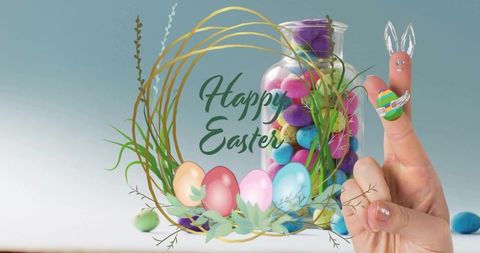 Happy easter finger bunny holding painted egg with pastel candy jar wreath spring flatlay